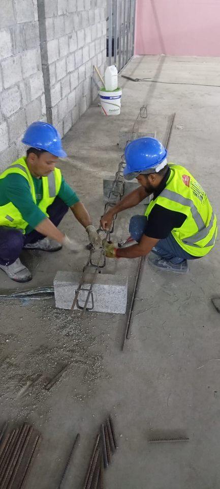 V CARE team members working on steel reinforcement at a Dubai site